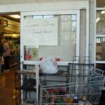 A sign and a cart full of food reminded shoppers at Shady Maple to buy one item to donate to the Food Drive. 