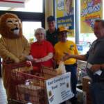 Members from the Schoeneck Club watch as a shopper donates food.  