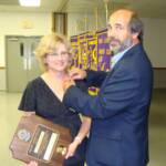 PDG Bruce pins his Partner in Service, Jamie, with her Melvin Jones pin.