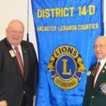 PCC Gus and DG Jim posing with the District's Banner
